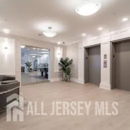 a view of a hallway with livingroom and furniture