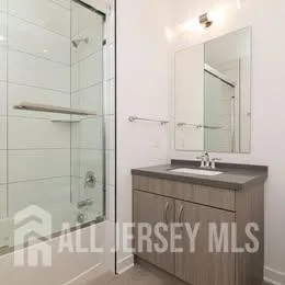 a kitchen with granite countertop a stove a sink and a refrigerator
