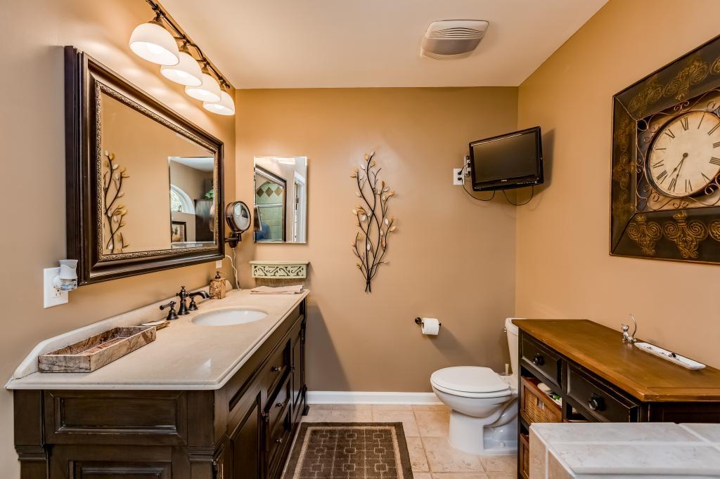 661 Beckwith Road Mount Juliet, TN 37122 - Photo 11 of 26 a bathroom with a sink a toilet and a mirror
