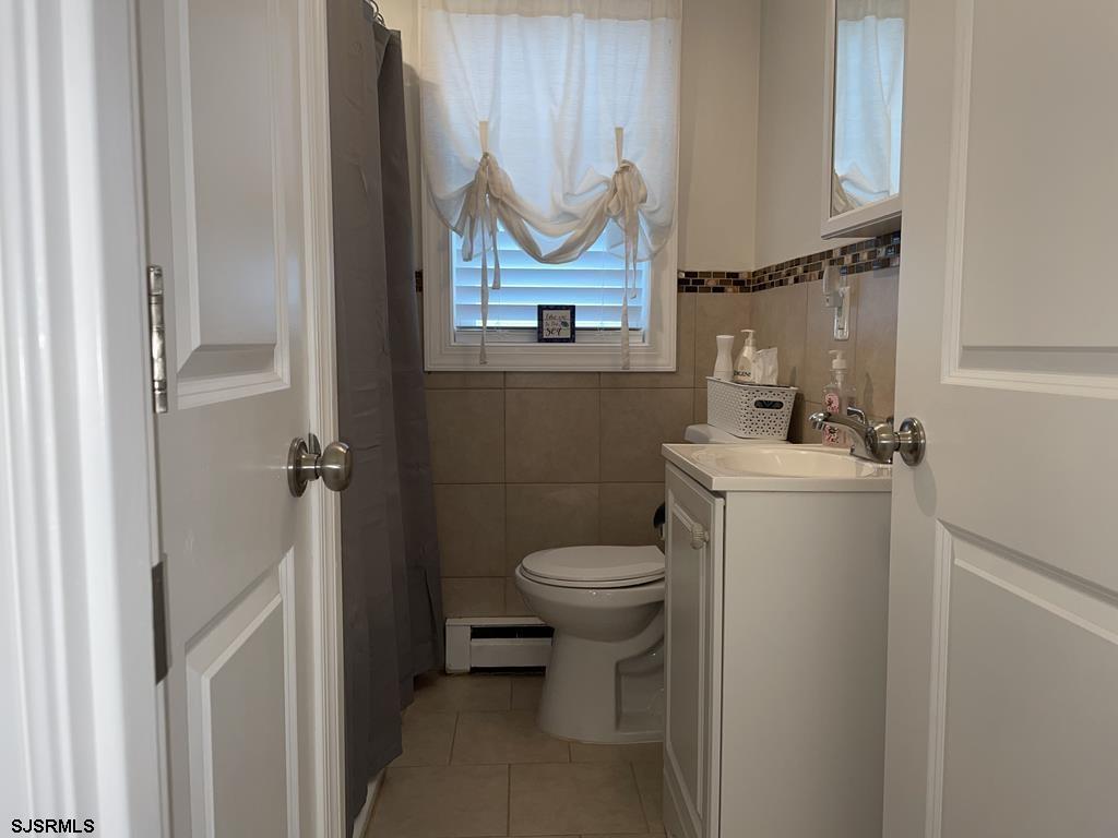 111 10th Street South, Unit B Brigantine, NJ 08203 - Photo 12 of 19 a bathroom with a sink a toilet and a mirror