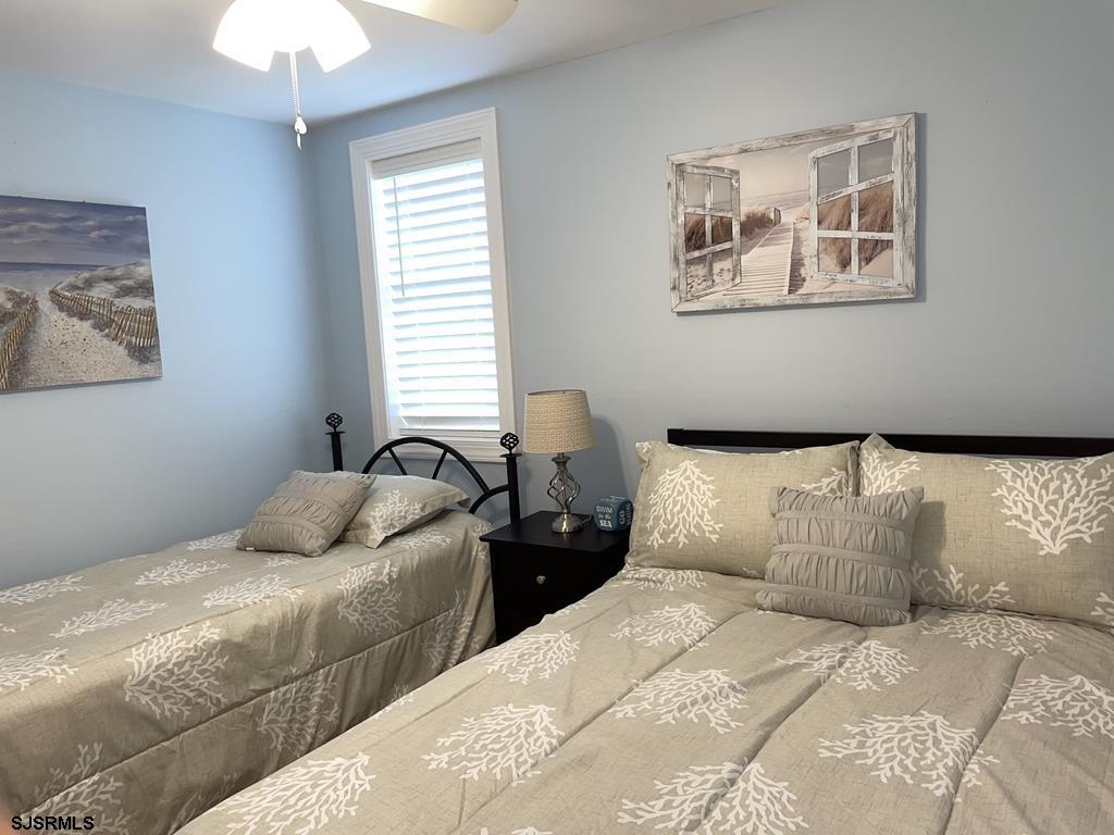 111 10th Street South, Unit B Brigantine, NJ 08203 - Photo 5 of 19 a bedroom with two beds and a chandelier