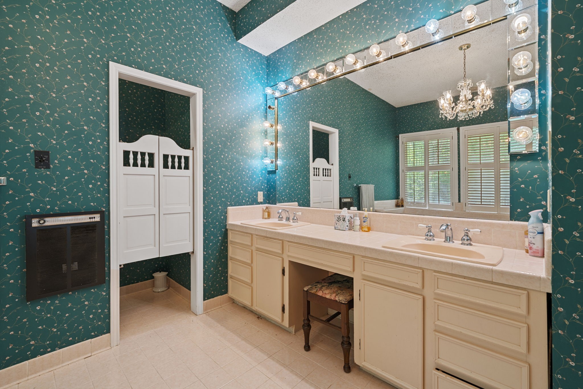 3541 Highway 159 La Grange, TX 78945 - Photo 29 of 38 This master ensuite includes a vanity, elegant lighting, a large mirror, and dual sinks.