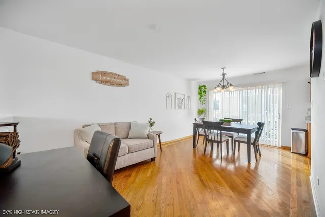 a view of a dining room with furniture and wooden floor