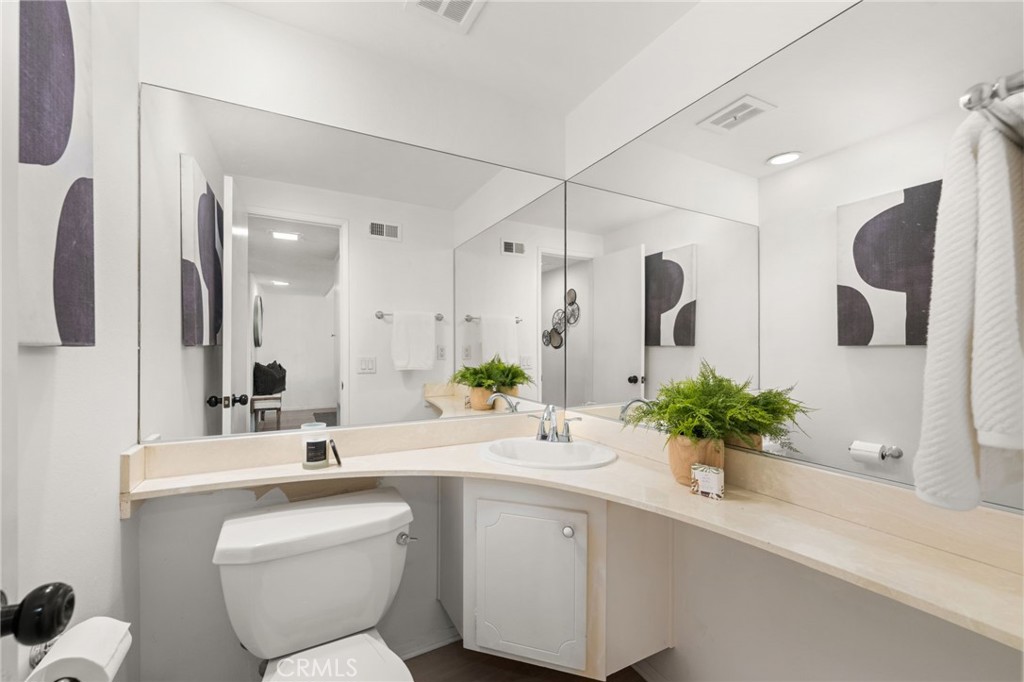 8242 Baldwin Circle Buena Park, CA 90621 - Photo 14 of 44 a bathroom with a sink mirror and vanity
