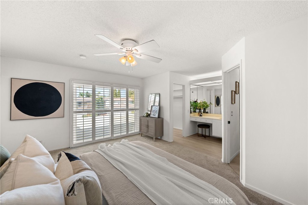 8242 Baldwin Circle Buena Park, CA 90621 - Photo 16 of 44 a spacious bedroom with a bed a window and a chandelier
