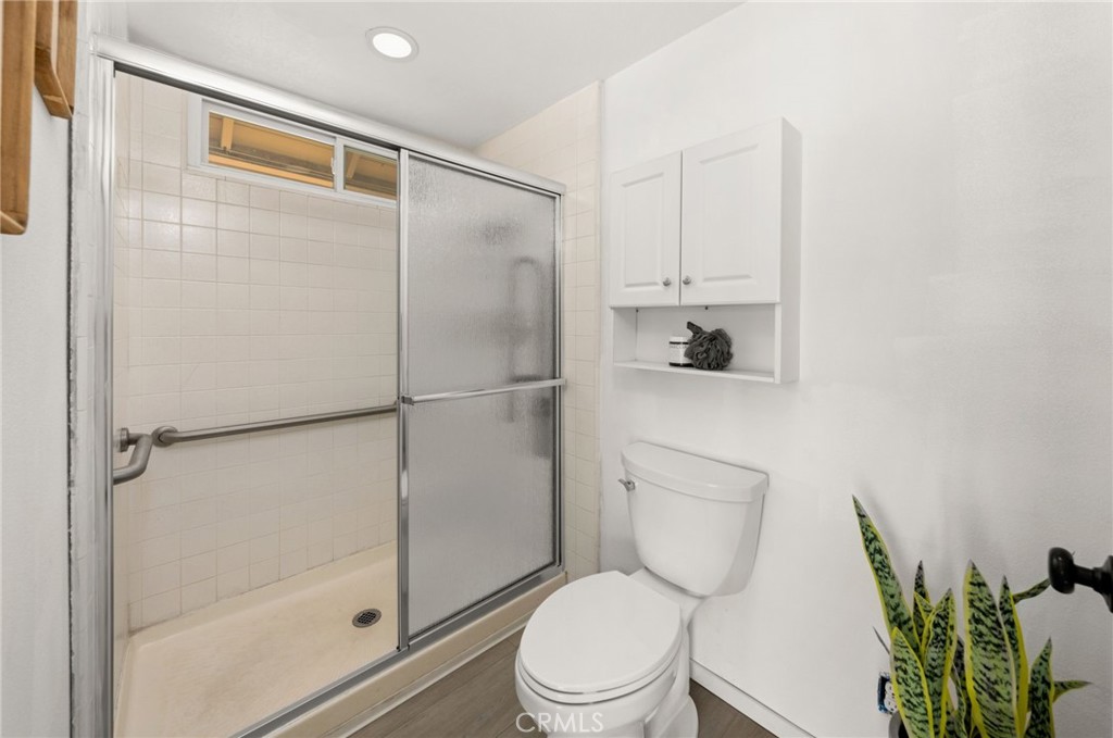 8242 Baldwin Circle Buena Park, CA 90621 - Photo 19 of 44 a bathroom with a toilet and a shower