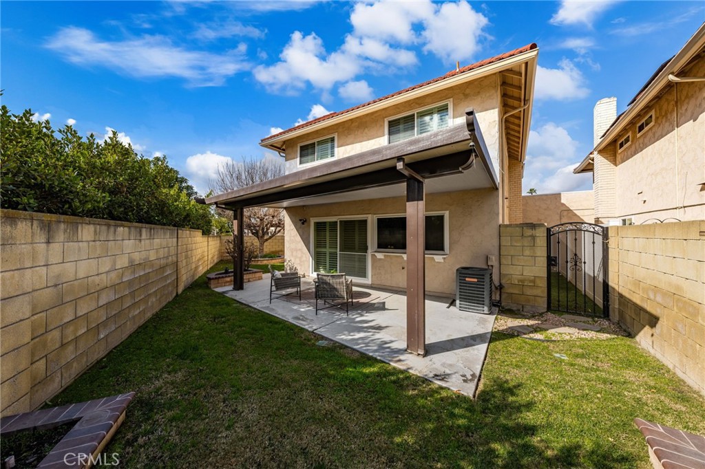 8242 Baldwin Circle Buena Park, CA 90621 - Photo 29 of 44 a view of a backyard with table and chairs with wooden fence