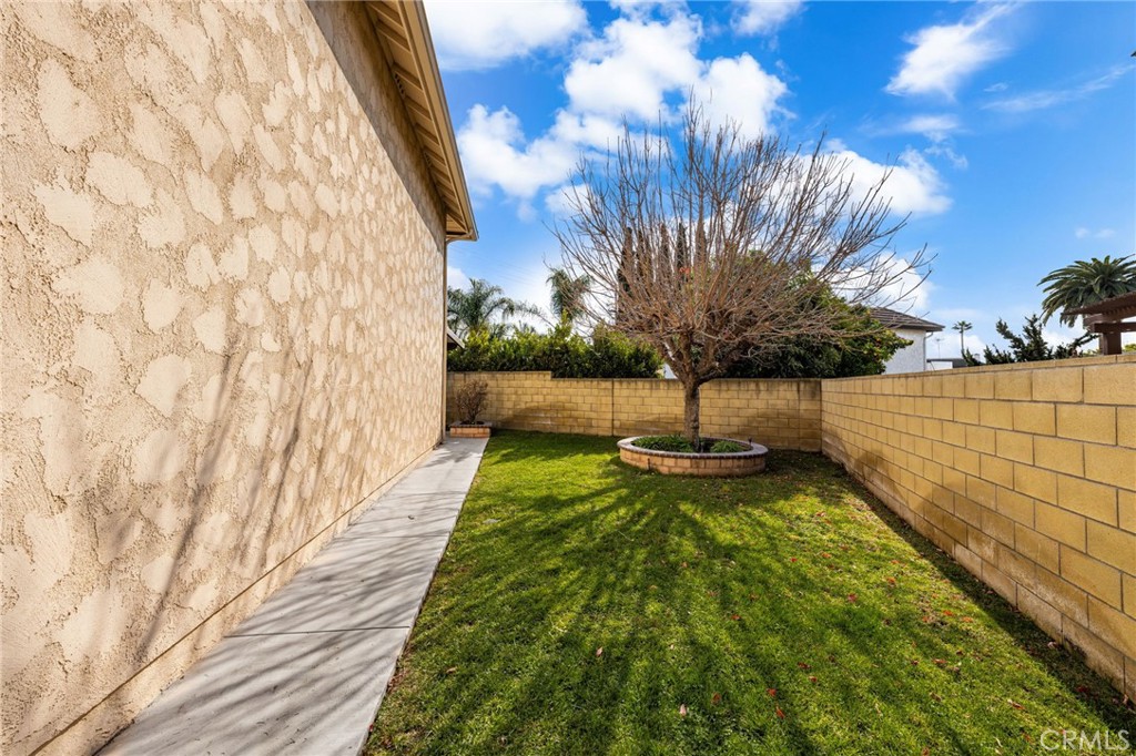 8242 Baldwin Circle Buena Park, CA 90621 - Photo 32 of 44 a view of a yard with wooden fence