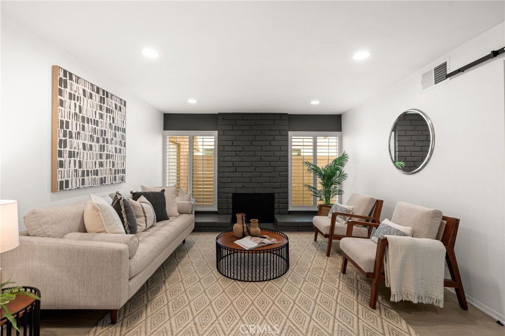 8242 Baldwin Circle Buena Park, CA 90621 - Photo 4 of 44 a living room with furniture potted plant and a fireplace