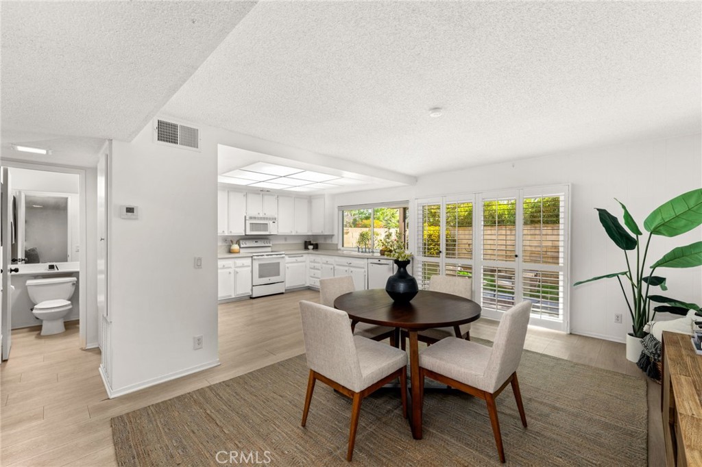 8242 Baldwin Circle Buena Park, CA 90621 - Photo 9 of 44 a view of a dining room with furniture and wooden floor
