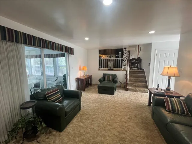 a living room with furniture fireplace and flat screen tv