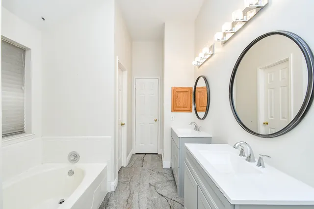 an empty room with a ceiling fan and a window