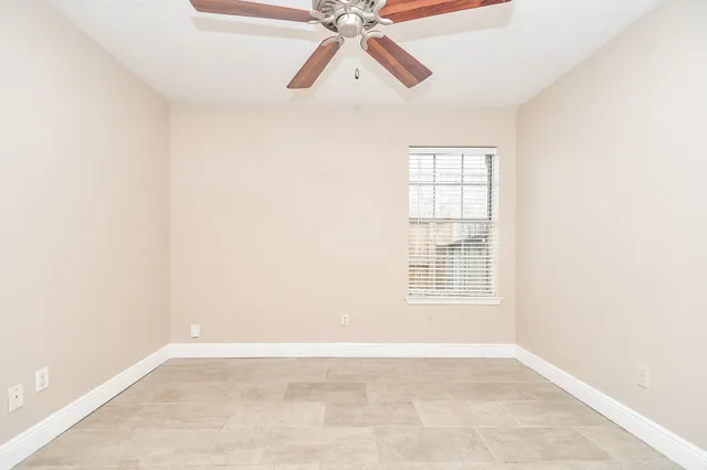 a view of empty room with ceiling fan