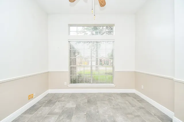 a kitchen with stainless steel appliances granite countertop a sink a stove cabinets and a living room view