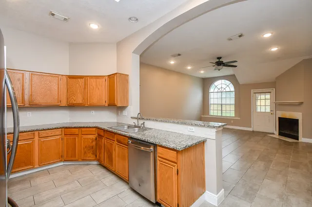a kitchen with stainless steel appliances granite countertop a sink stove and cabinets