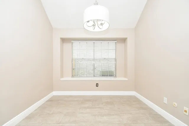 an empty room with closet and ceiling fan