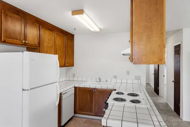 a kitchen with a refrigerator and a sink