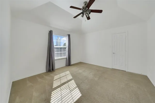 a view of a room with a ceiling fan