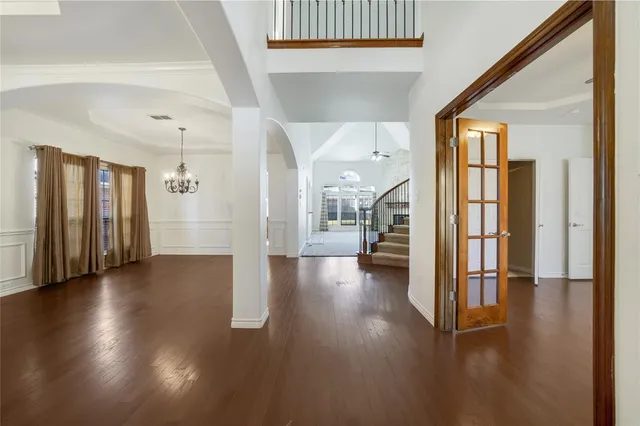 a view of a hallway with wooden floor and windows