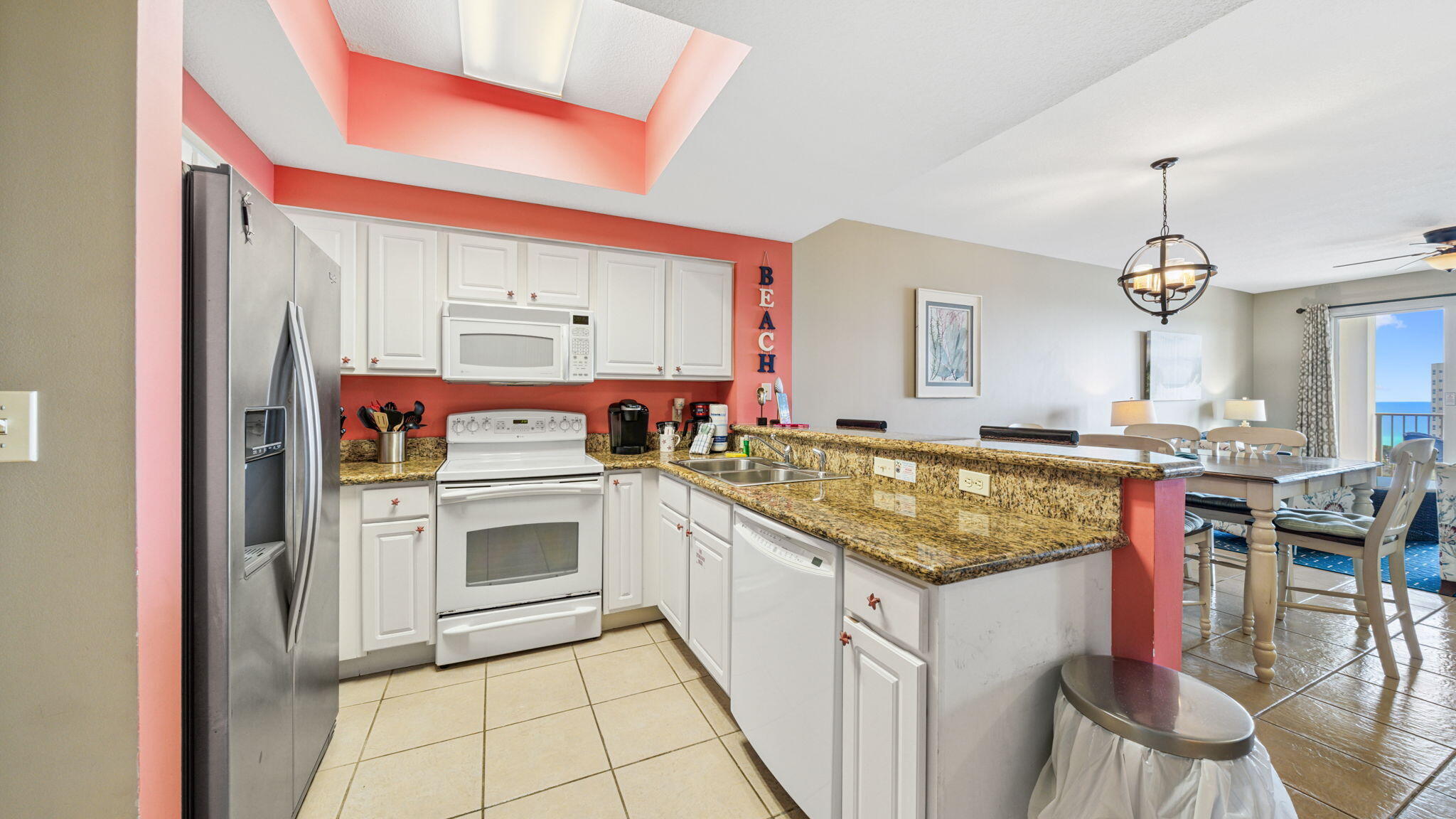 122 Seascape Drive, Unit 902 Miramar Beach, FL 32550 - Photo 8 of 20 a kitchen with stainless steel appliances granite countertop a stove and a sink