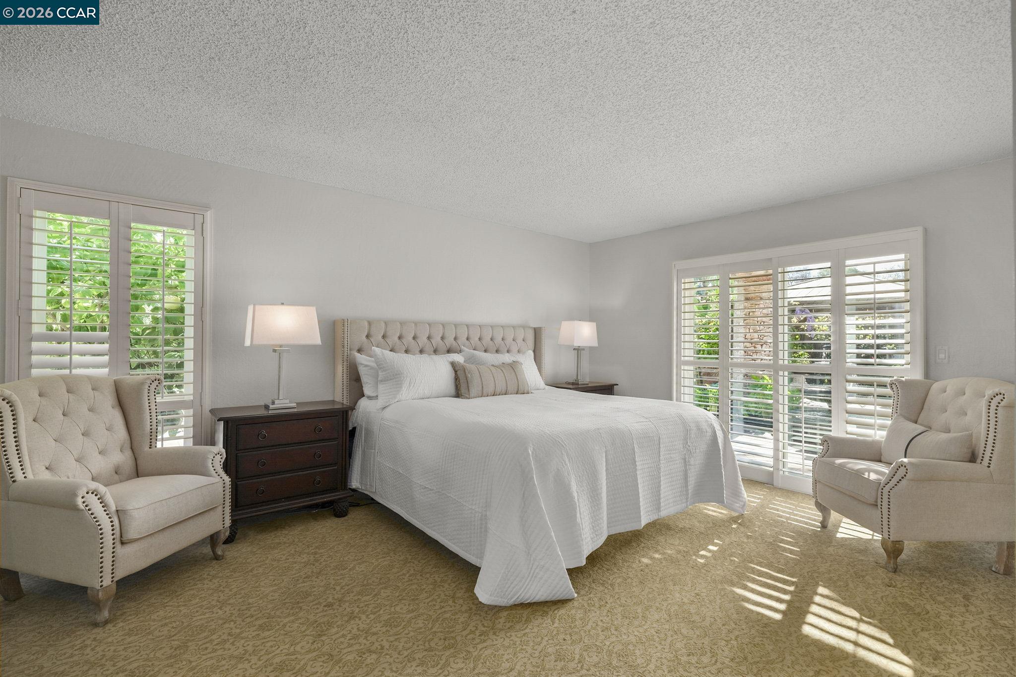 4151 Storey Lane Concord, CA 94518 - Photo 17 of 40 a spacious bedroom with a bed and glass window