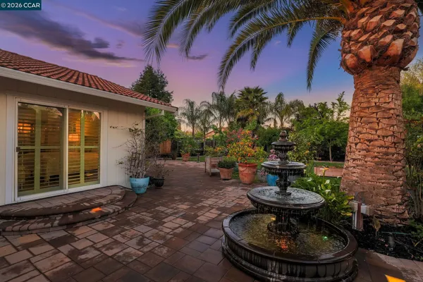 a view of a backyard of a house with a patio
