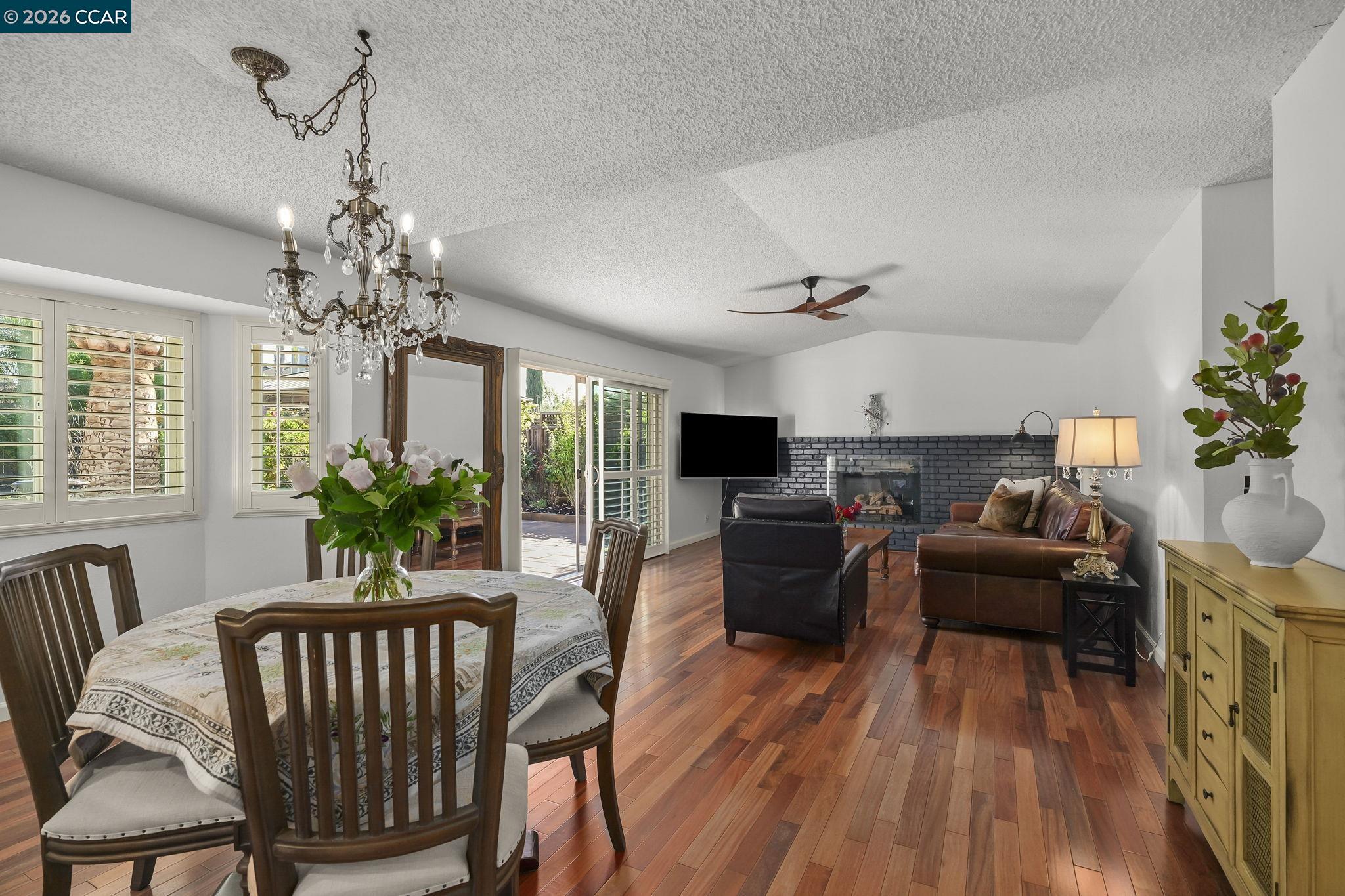 4151 Storey Lane Concord, CA 94518 - Photo 7 of 40 a living room with furniture a chandelier and a fireplace