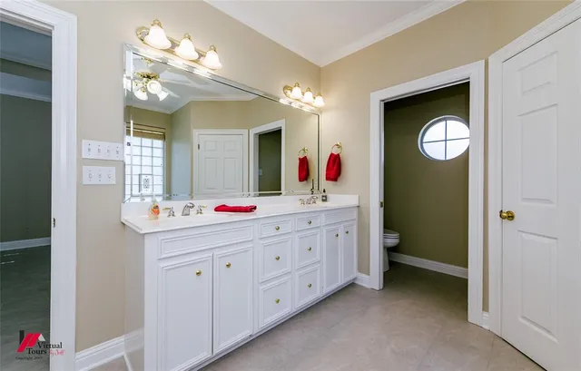 a bathroom with a toilet sink and mirror