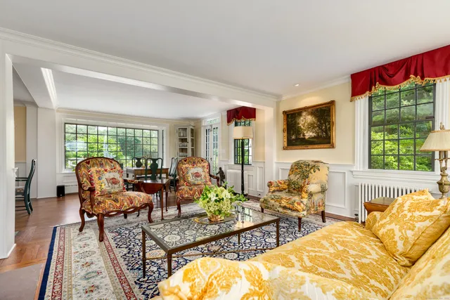 a living room with furniture fireplace and window