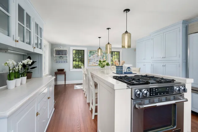a kitchen with stove and cabinets