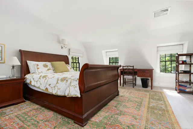 a bedroom with a large bed and a window