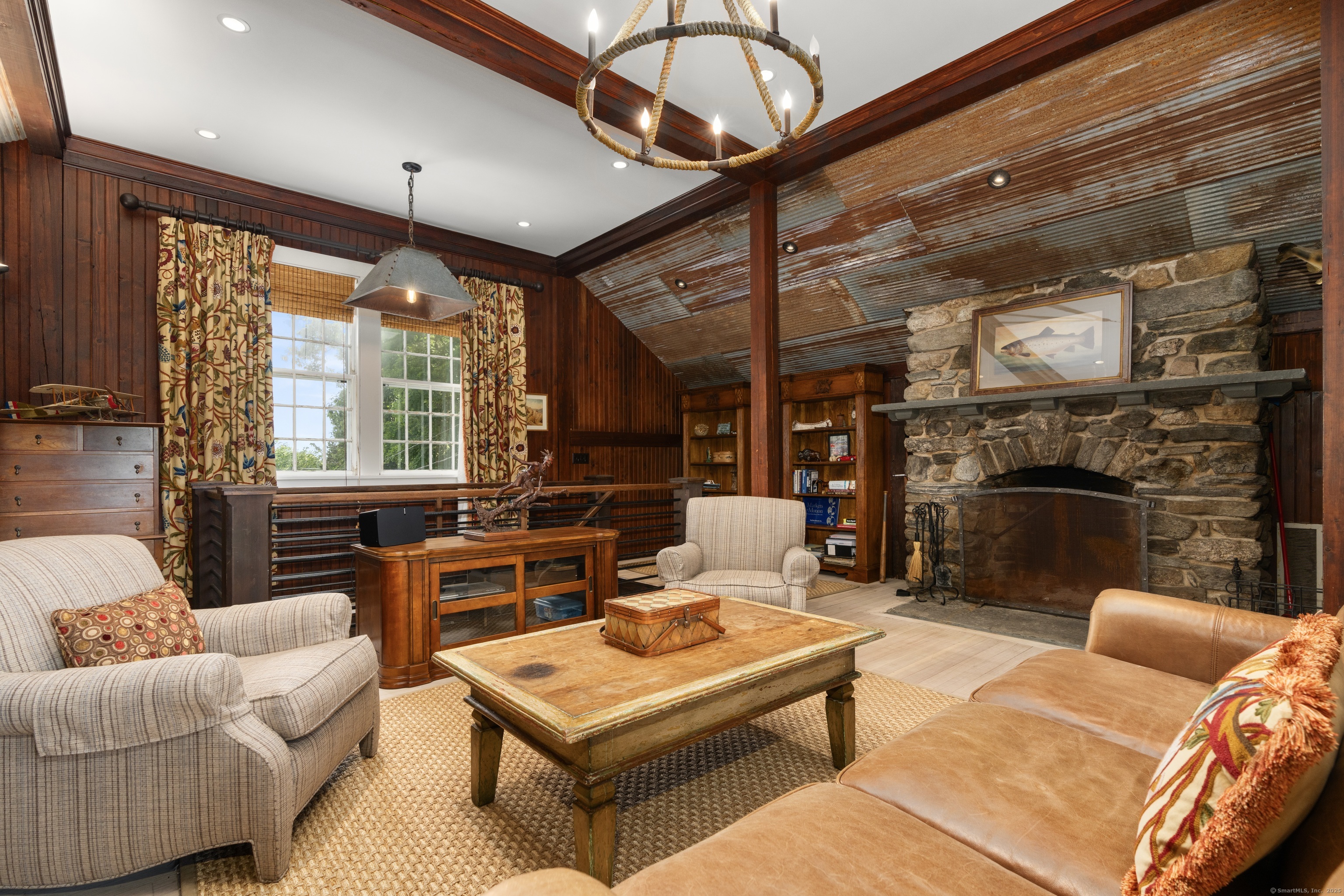 117 Elys Ferry Road Lyme, CT 06371 - Photo 23 of 40 a living room with furniture a ceiling fan and a fireplace