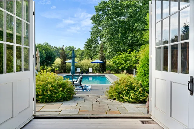 a view of potted plants and a fountain in front of a door