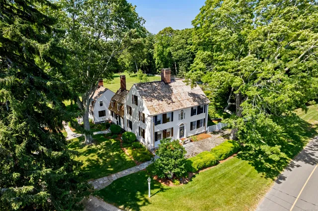 an aerial view of a house with a yard large trees and plants