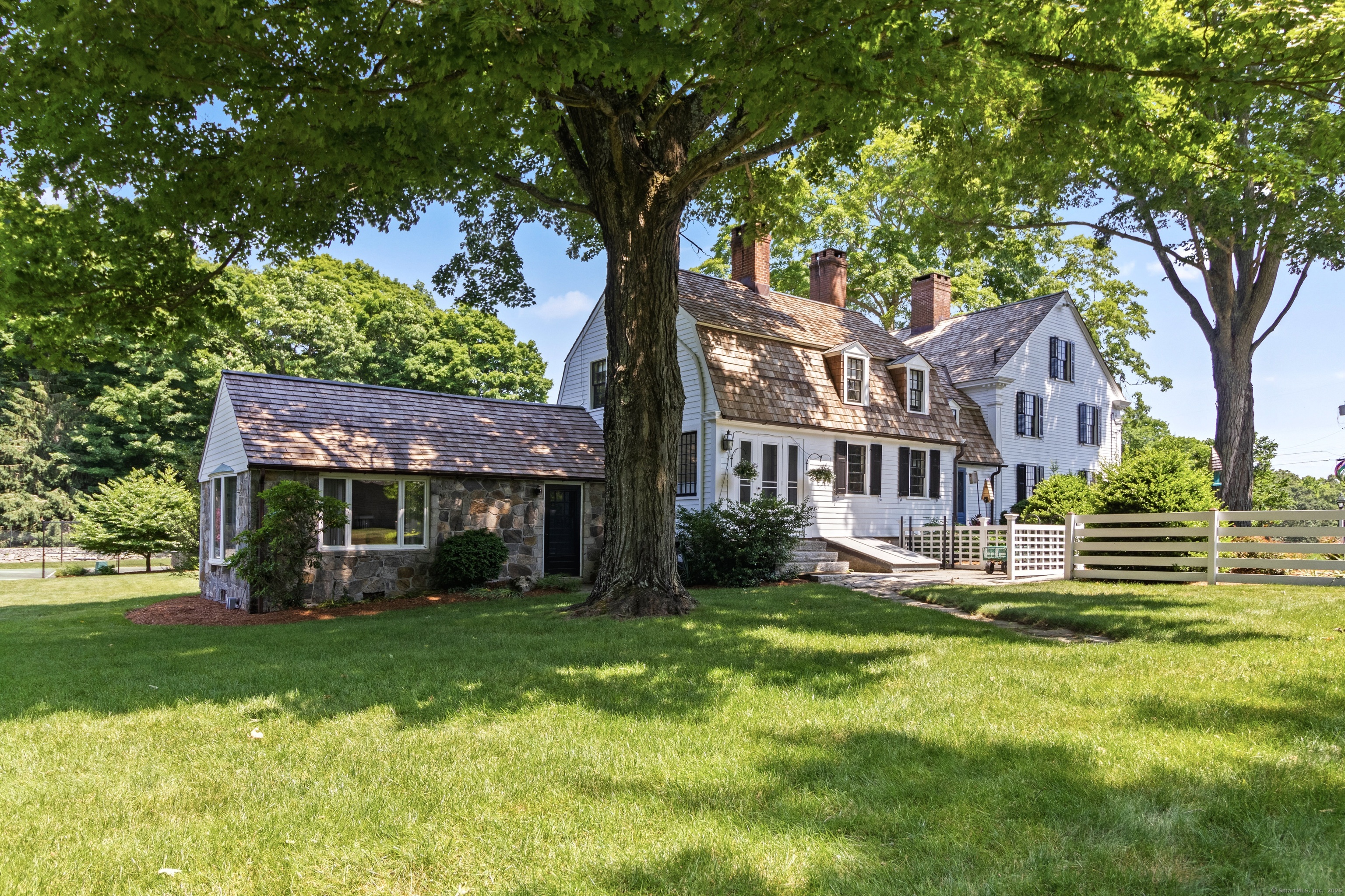 117 Elys Ferry Road Lyme, CT 06371 - Photo 35 of 40 a front view of a house with a yard table and chairs