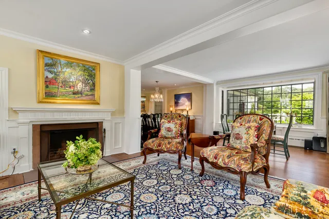 a living room with furniture a fireplace and a table