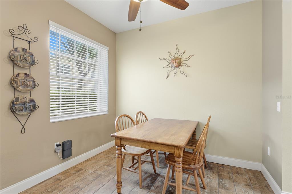 6216 Rosefinch Court, Unit 102 Lakewood Ranch, FL 34202 - Photo 15 of 45 a view of a dining room with furniture and window