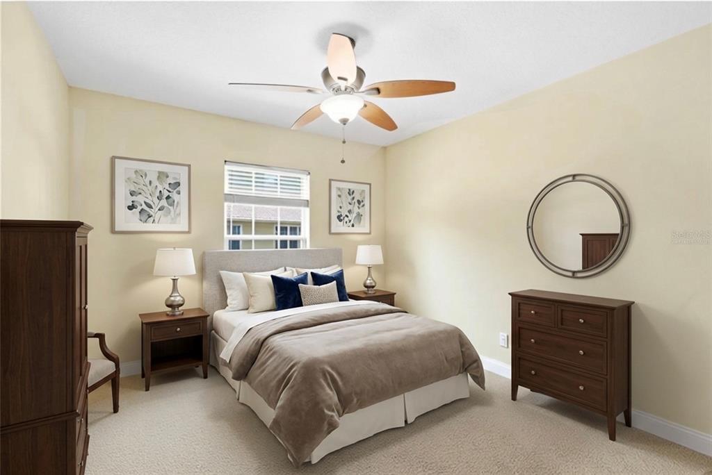 6216 Rosefinch Court, Unit 102 Lakewood Ranch, FL 34202 - Photo 20 of 45 a bedroom with a bed and a chandelier