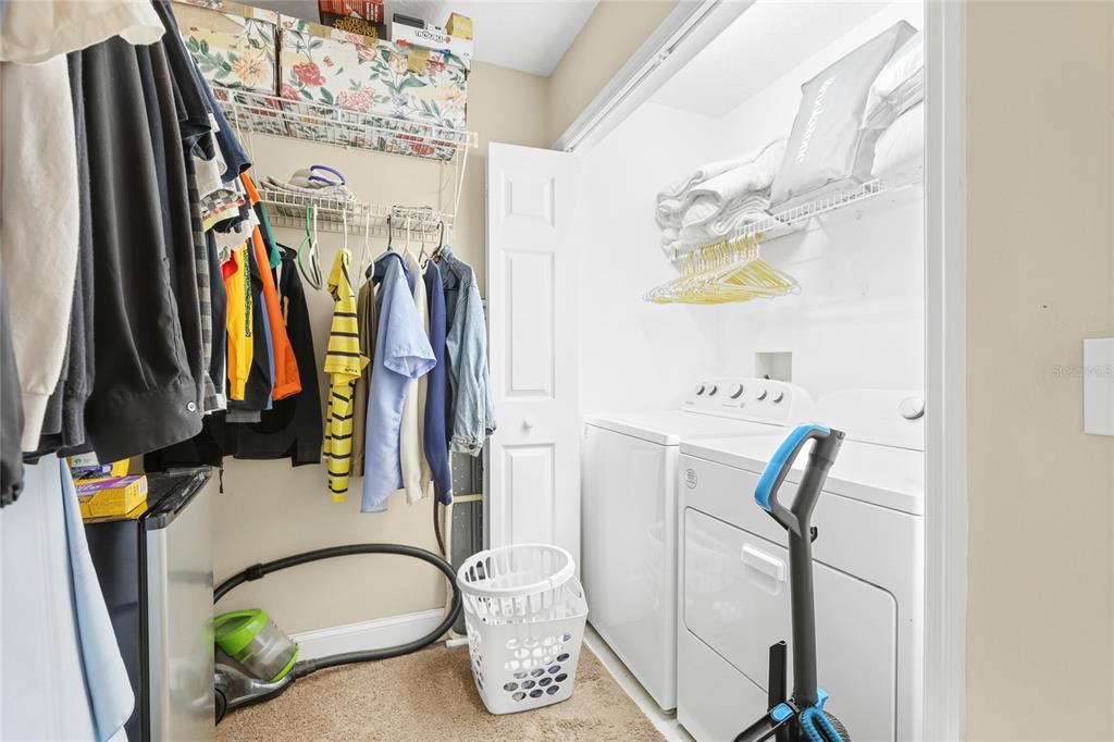 6216 Rosefinch Court, Unit 102 Lakewood Ranch, FL 34202 - Photo 21 of 45 a view of walk in closet with clothes and shoes