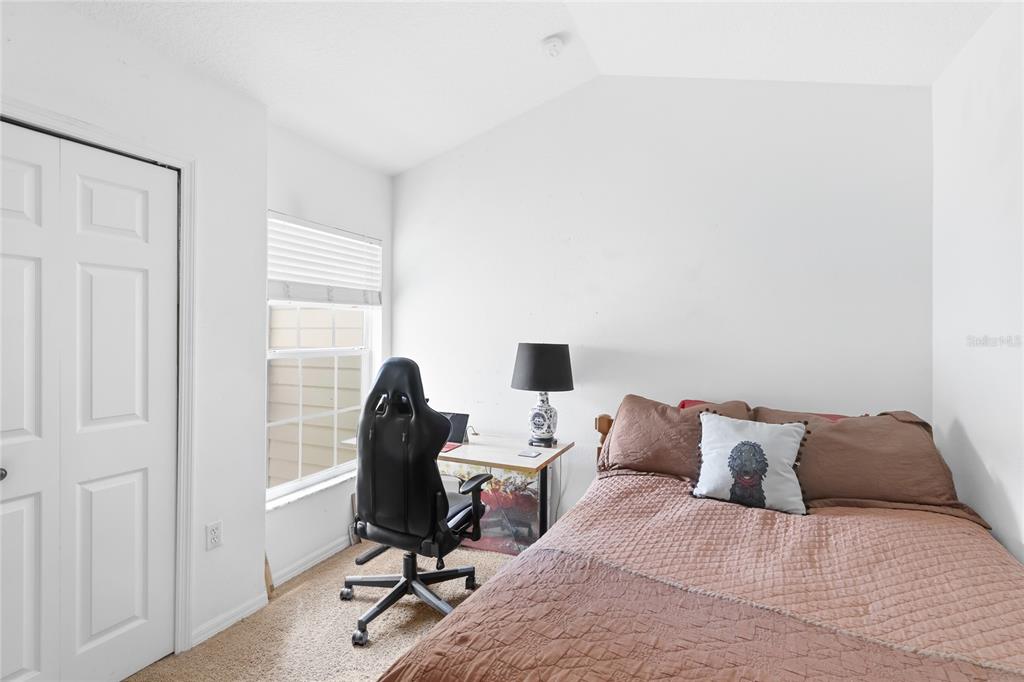 6216 Rosefinch Court, Unit 102 Lakewood Ranch, FL 34202 - Photo 22 of 45 a bedroom with a bed and a chair