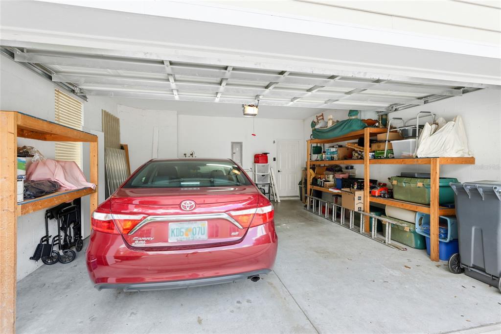 6216 Rosefinch Court, Unit 102 Lakewood Ranch, FL 34202 - Photo 26 of 45 a garage with a white cabinets and potted plant