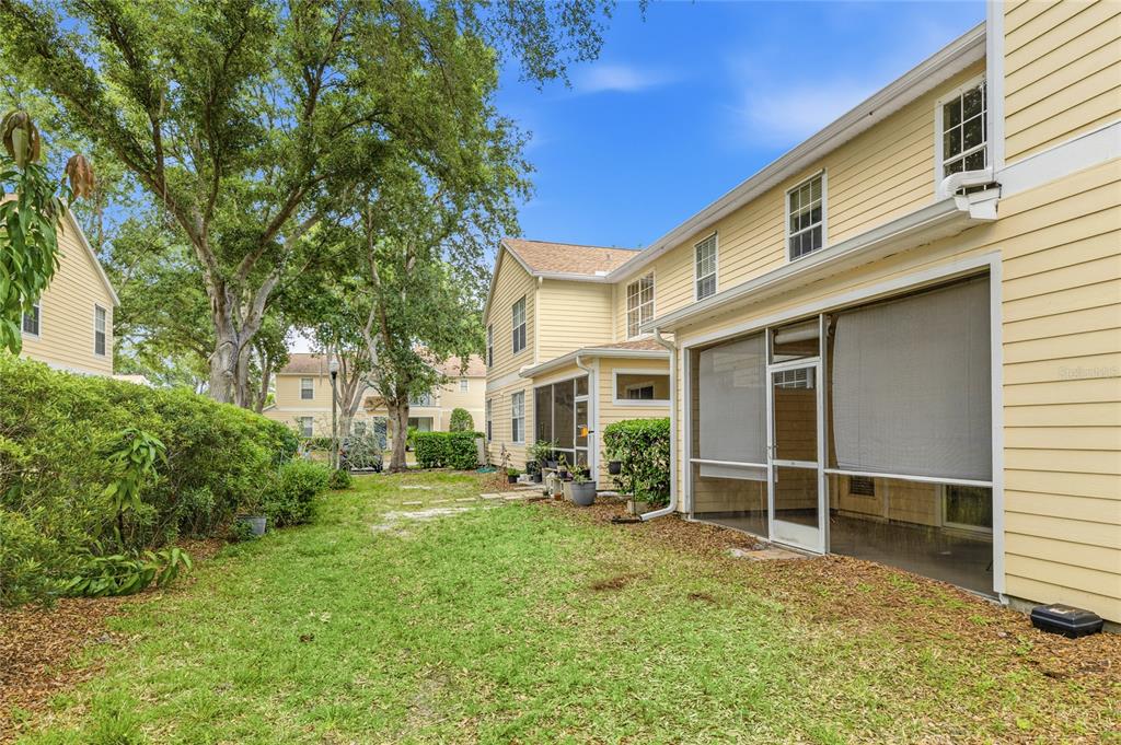 6216 Rosefinch Court, Unit 102 Lakewood Ranch, FL 34202 - Photo 27 of 45 a view of a house with backyard porch and garden