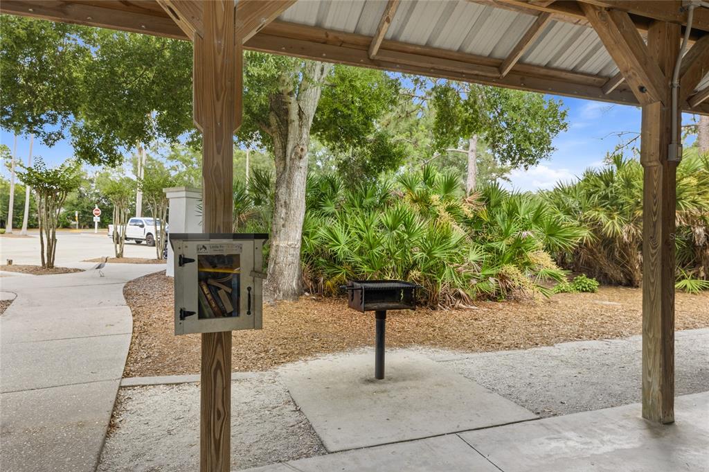6216 Rosefinch Court, Unit 102 Lakewood Ranch, FL 34202 - Photo 35 of 45 a view of a backyard with table and chairs potted plants