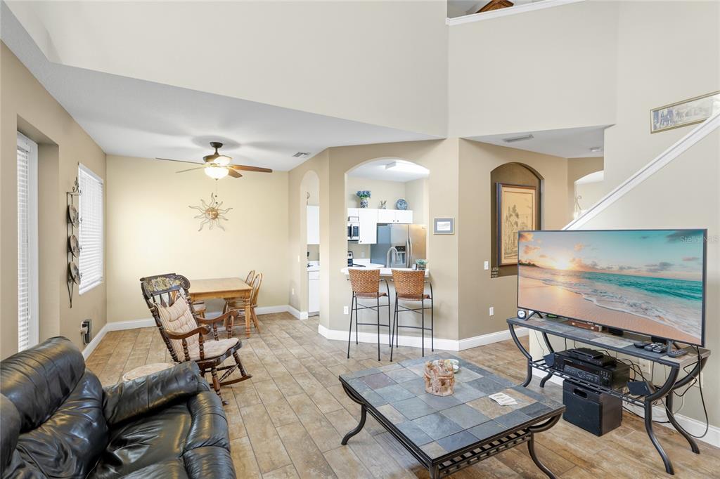 6216 Rosefinch Court, Unit 102 Lakewood Ranch, FL 34202 - Photo 7 of 45 a living room with furniture a rug and a flat screen tv