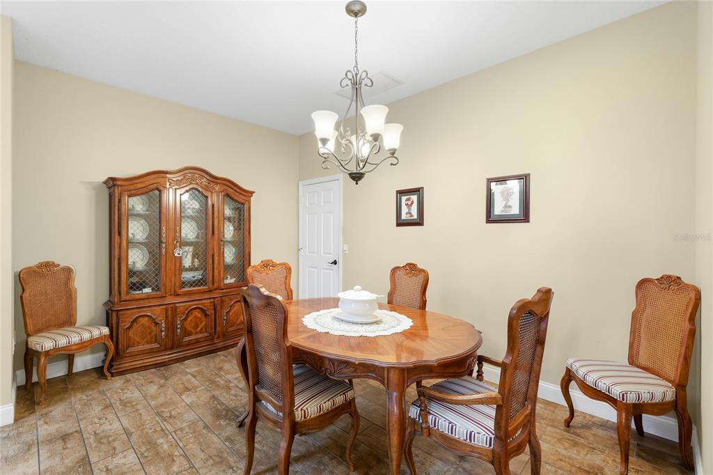6216 Rosefinch Court, Unit 102 Lakewood Ranch, FL 34202 - Photo 10 of 45 a view of a dining room with furniture and chandelier