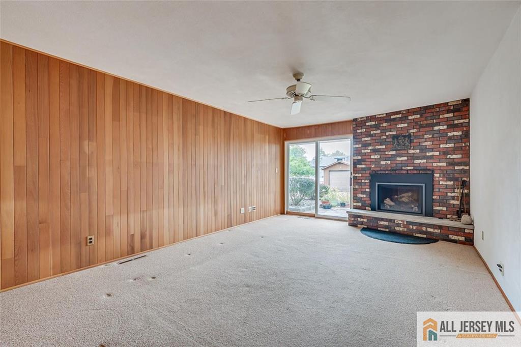21 Tyndall Road Kendall Park, NJ 08824 - Photo 7 of 33 a view of an empty room with a fireplace and a window
