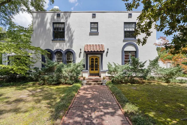 a front view of a house with garden