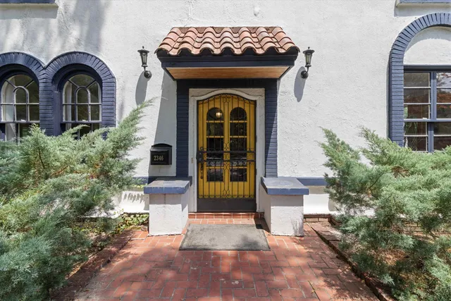 a front view of a house with garden