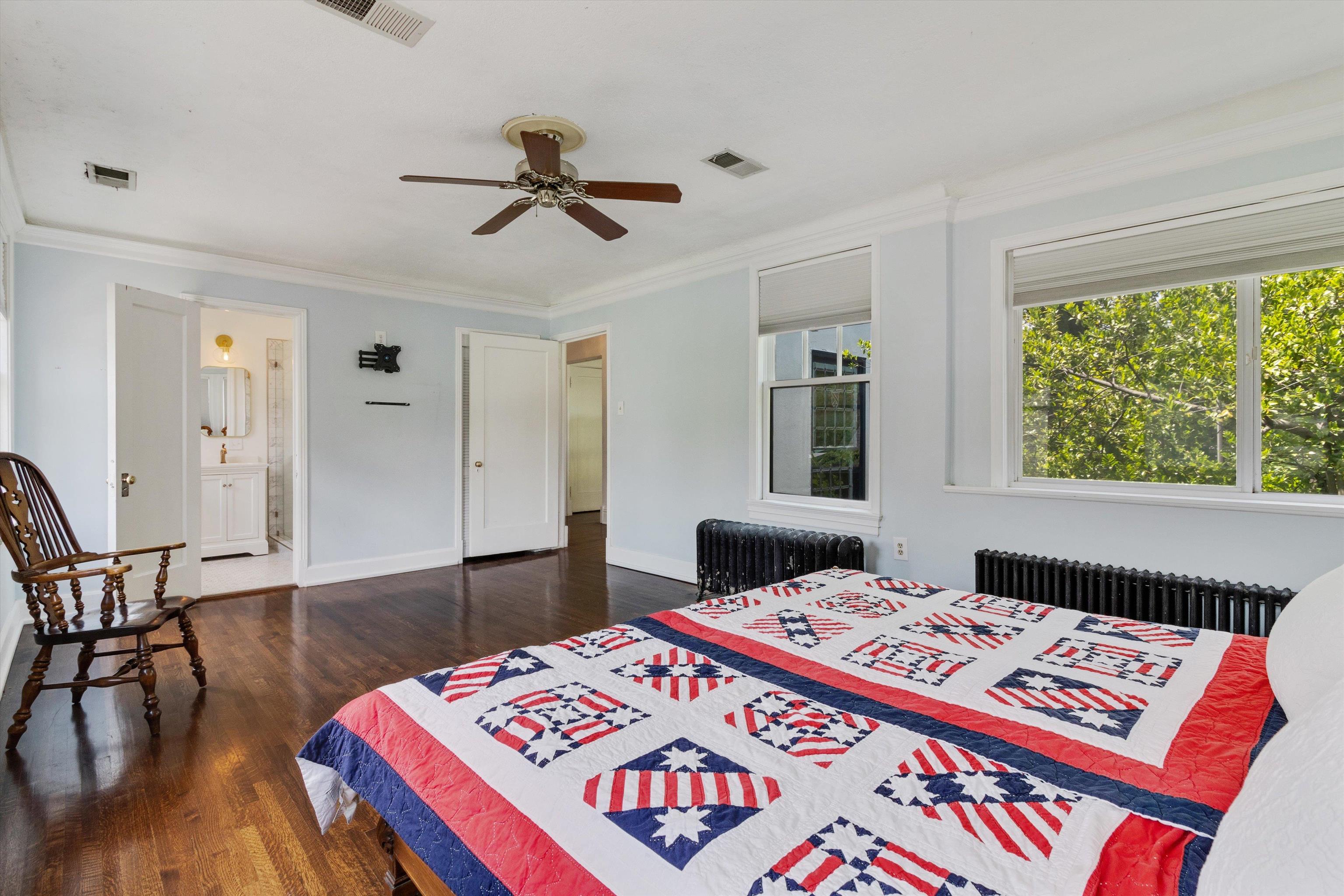2346 North Strathmore Circle Memphis, TN 38112 - Photo 22 of 40 a bedroom with a bed and a lamp on table with wooden floor