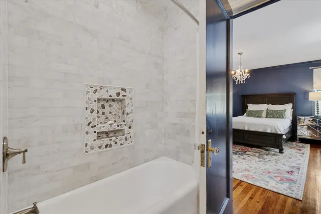 a bathroom with a bathtub and a shower
